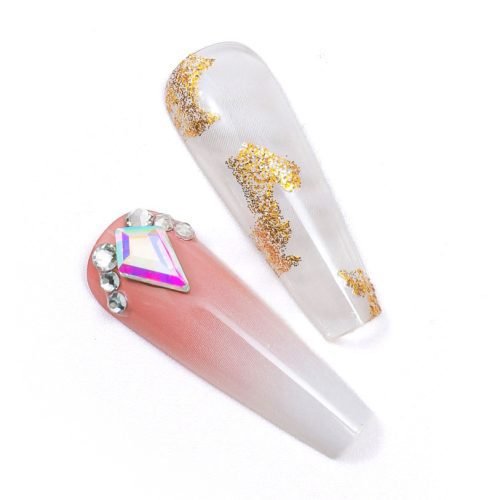 Close-up view of 2 handmade press-on coffin nails, in light red, white, and gold glitter with diamonds affixed.