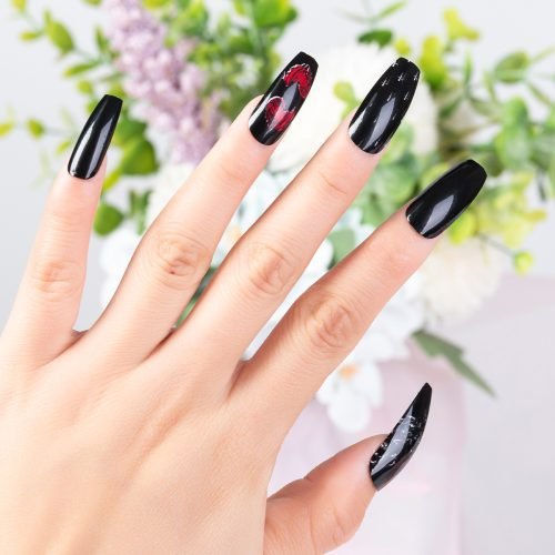 A hand sporting a set of coffin press-on nails in a black and red color mix, featuring a unique nail art design.