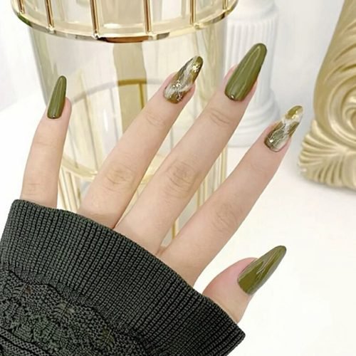 A hand modeling a set of press-on nails in mixed green, featuring a unique design, in an oval shape.