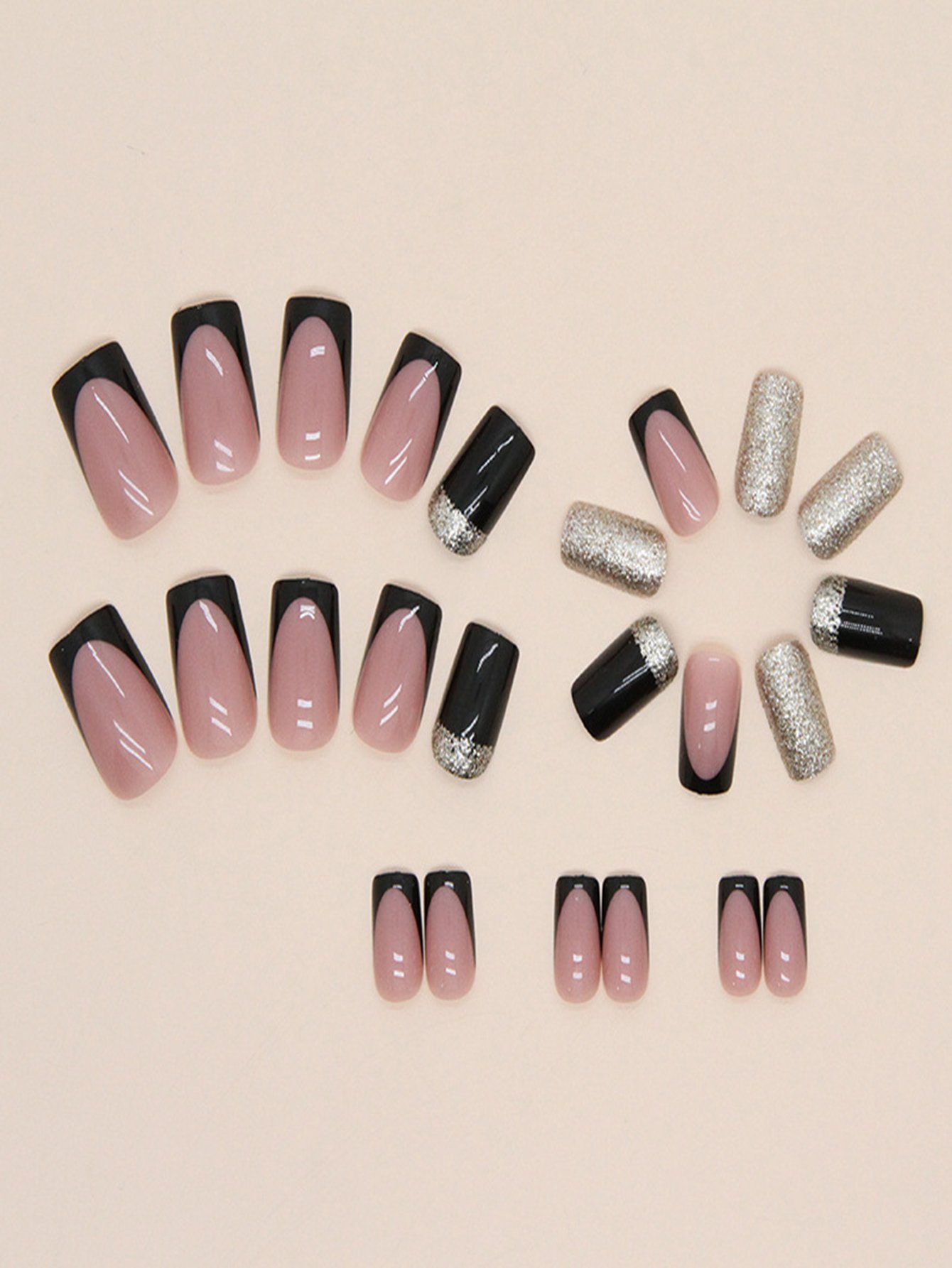 Overhead view of square-shaped fake nails featuring three designs: pink with black French tips, dazzling gold glitter, and striking black with gold glitter highlights.