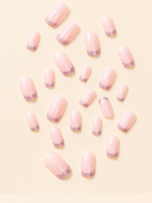 Top-down view of a 24-piece set of short square-shaped press-on nails in a nude shade with glittery French tips.